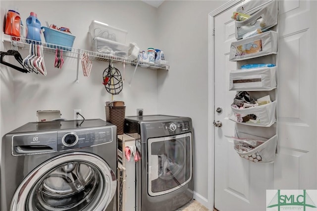 washroom featuring laundry area and washer and clothes dryer