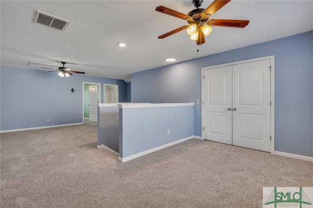 spare room featuring recessed lighting, visible vents, a ceiling fan, light carpet, and baseboards