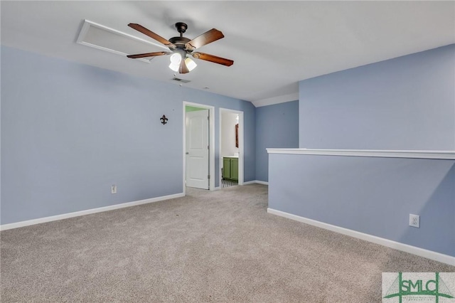 unfurnished room with a ceiling fan, light carpet, and baseboards