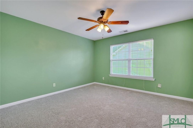 empty room featuring a ceiling fan, carpet flooring, visible vents, and baseboards