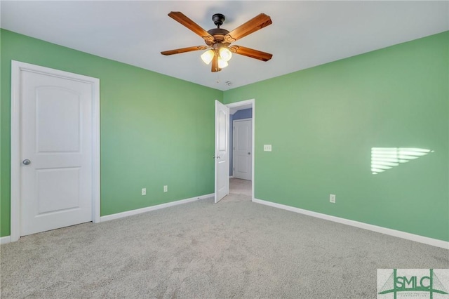 unfurnished room with light colored carpet, ceiling fan, and baseboards