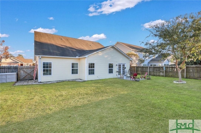 rear view of house featuring a patio area, a fenced backyard, and a lawn