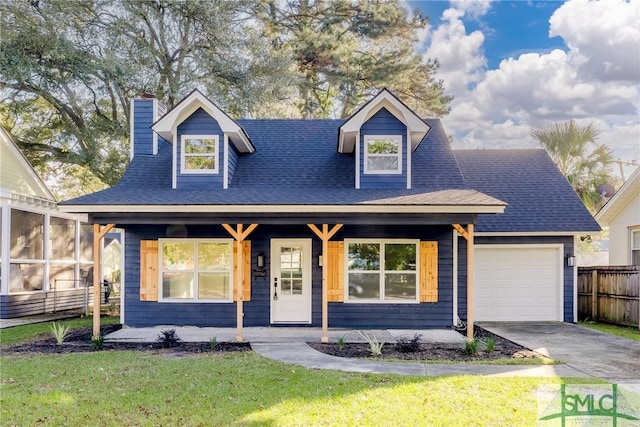 view of front of property featuring a porch, a garage, a sunroom, and a front lawn