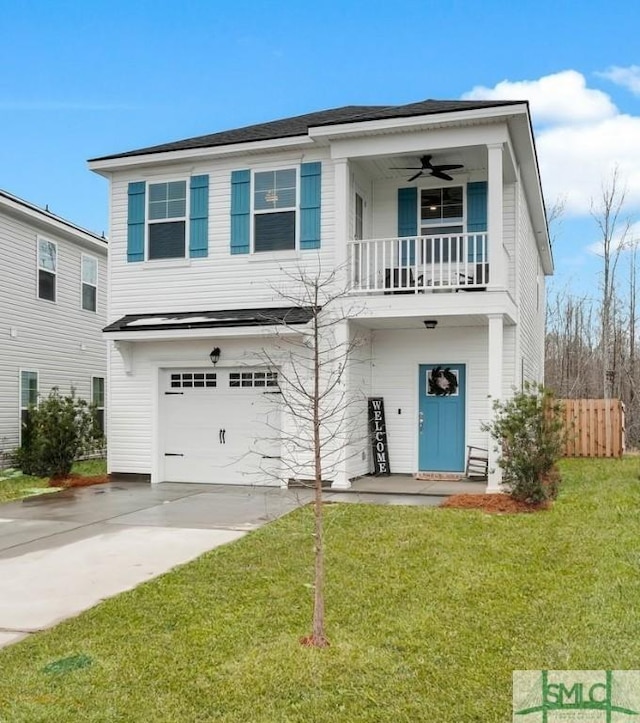 view of front of property with a garage, a front lawn, ceiling fan, and a balcony