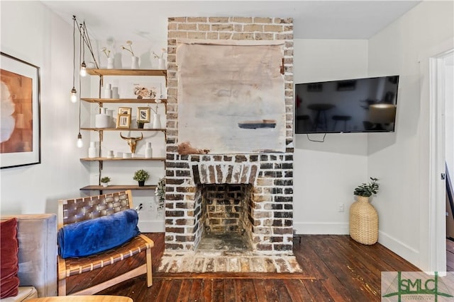 living room with a fireplace and dark hardwood / wood-style floors