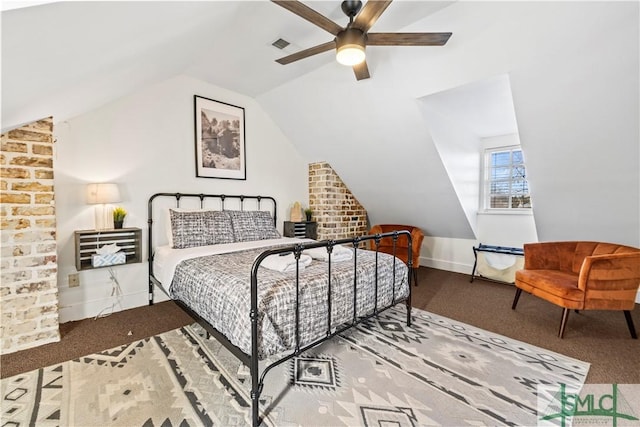 carpeted bedroom with ceiling fan and vaulted ceiling