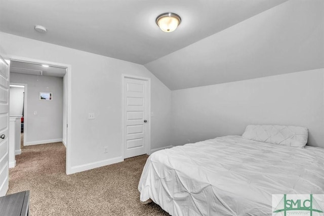 carpeted bedroom featuring lofted ceiling