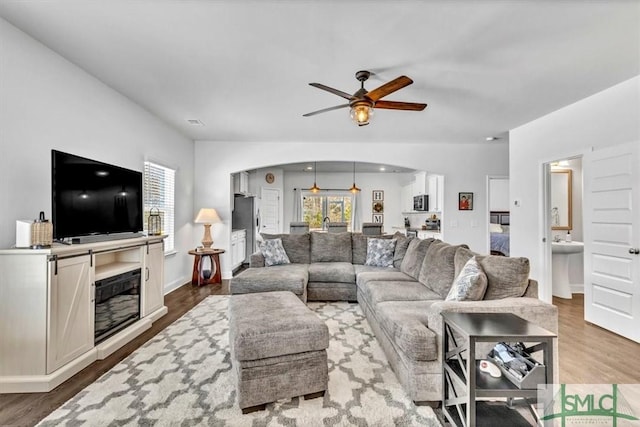 living room with ceiling fan and light hardwood / wood-style floors