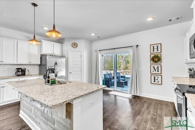 kitchen featuring a kitchen island with sink, sink, white cabinetry, and appliances with stainless steel finishes