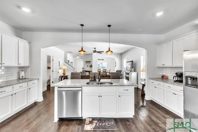 kitchen featuring pendant lighting, sink, backsplash, stainless steel appliances, and white cabinets