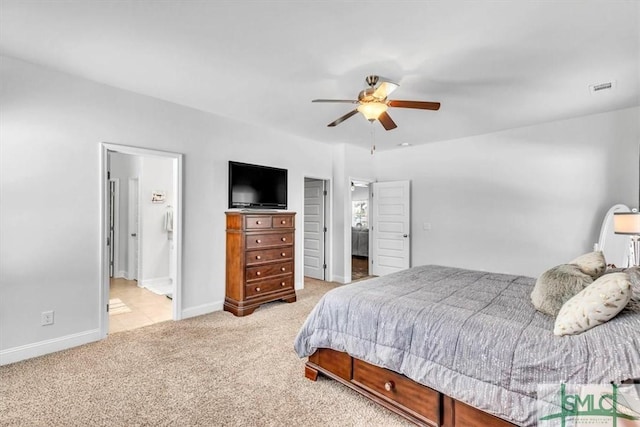 carpeted bedroom with connected bathroom and ceiling fan