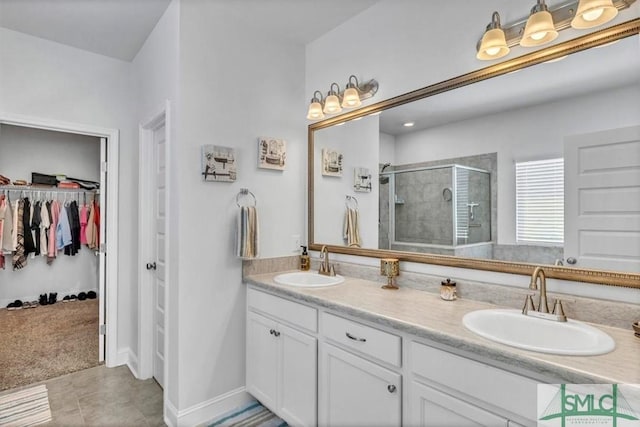 bathroom featuring an enclosed shower, vanity, and tile patterned flooring