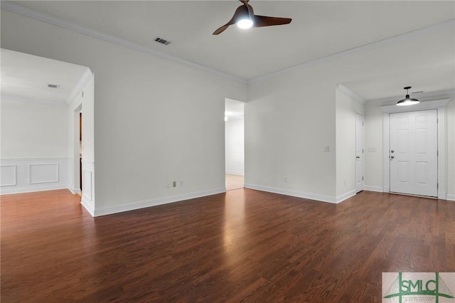 spare room with ornamental molding, dark hardwood / wood-style floors, and ceiling fan