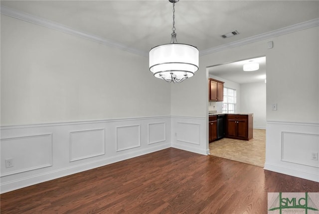 unfurnished dining area with crown molding and wood-type flooring