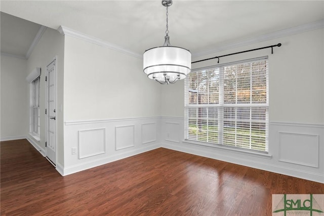 unfurnished dining area with crown molding, dark hardwood / wood-style floors, and a notable chandelier