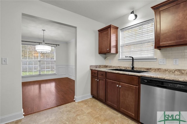 kitchen with pendant lighting, sink, a wealth of natural light, and stainless steel dishwasher