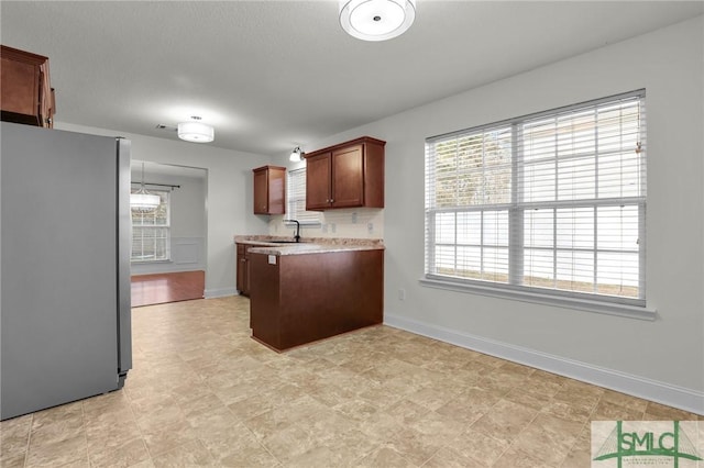 kitchen featuring sink and stainless steel refrigerator