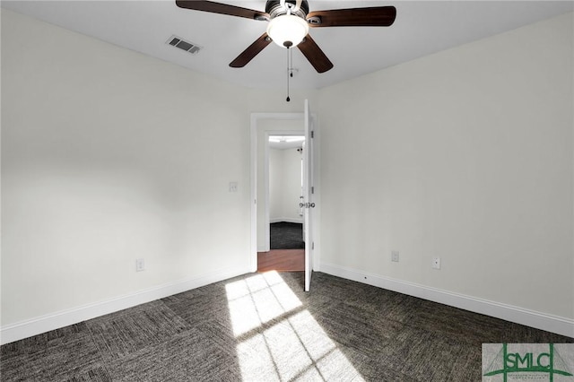 carpeted spare room with ceiling fan