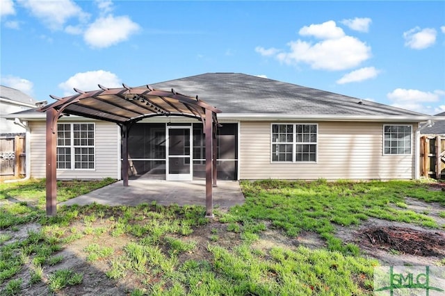 back of house featuring a pergola, a patio area, and a sunroom