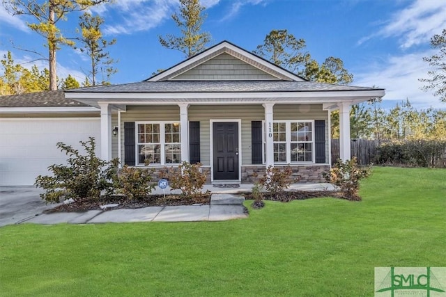 view of front of house with a garage and a front lawn