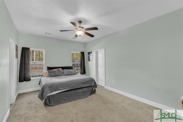 bedroom with light colored carpet and ceiling fan