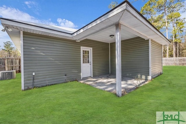 back of property featuring a yard, a patio area, and central air condition unit