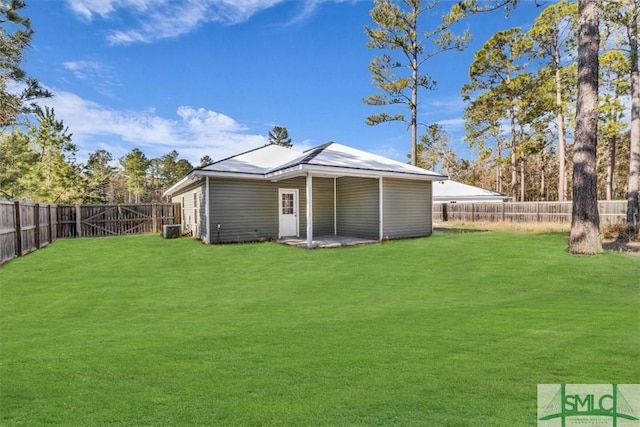 back of property with cooling unit and a lawn