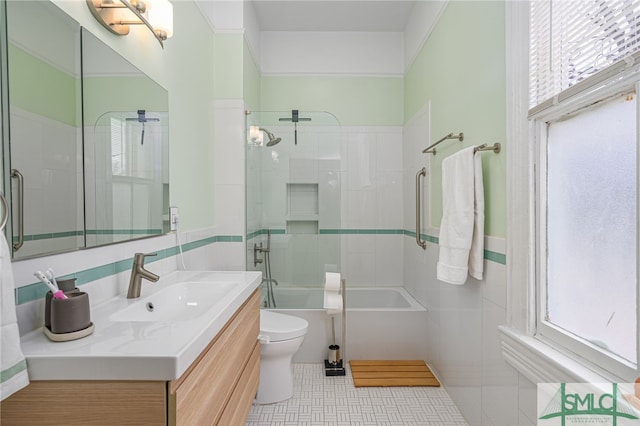 524 E Henry St, Savannah, GA 31401 - full bathroom with toilet, vanity, shower / bath combination with glass door, and tile walls