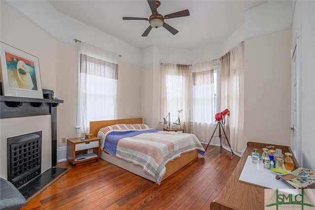 bedroom featuring dark hardwood / wood-style floors and ceiling fan