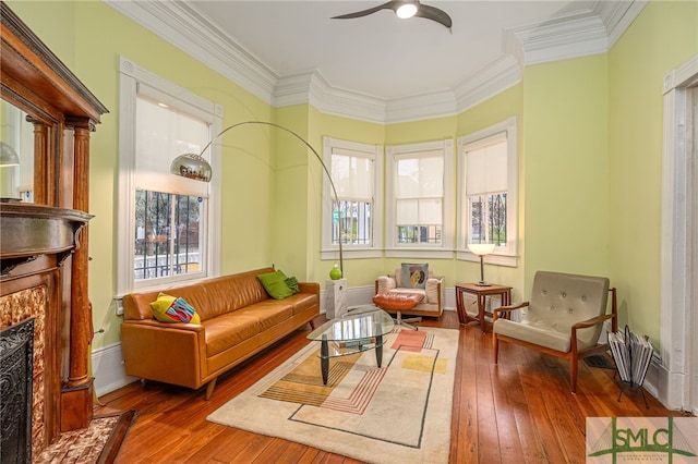 524 E Henry St, Savannah, GA 31401 - living area with a ceiling fan, wood-type flooring, a premium fireplace, and crown molding