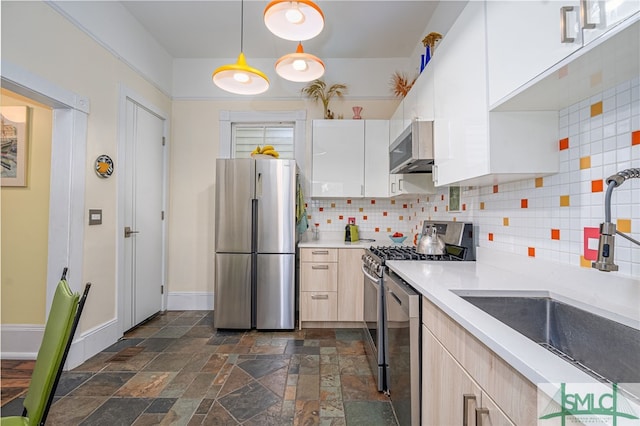 kitchen featuring sink, white cabinets, backsplash, hanging light fixtures, and stainless steel appliances