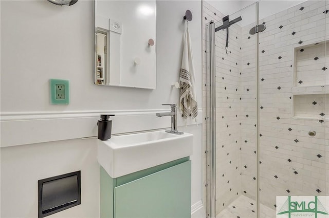 bathroom with vanity and a shower with shower door