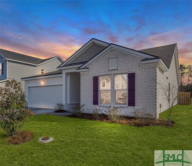 view of front of house with a garage and a lawn