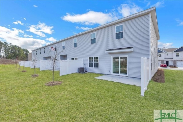 back of property featuring cooling unit, a yard, and a patio