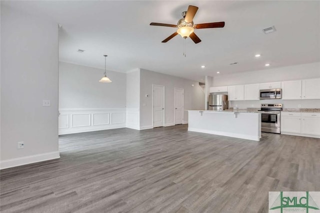 unfurnished living room with hardwood / wood-style floors and ceiling fan