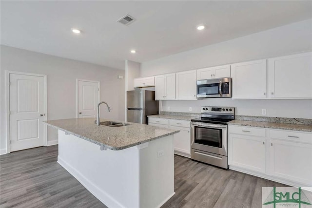 kitchen featuring white cabinetry, appliances with stainless steel finishes, sink, and a center island with sink