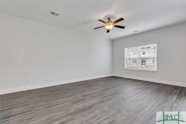 unfurnished room with dark hardwood / wood-style flooring and ceiling fan