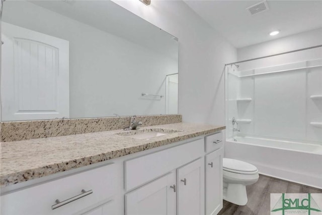 full bathroom featuring shower / bathtub combination, wood-type flooring, toilet, and vanity