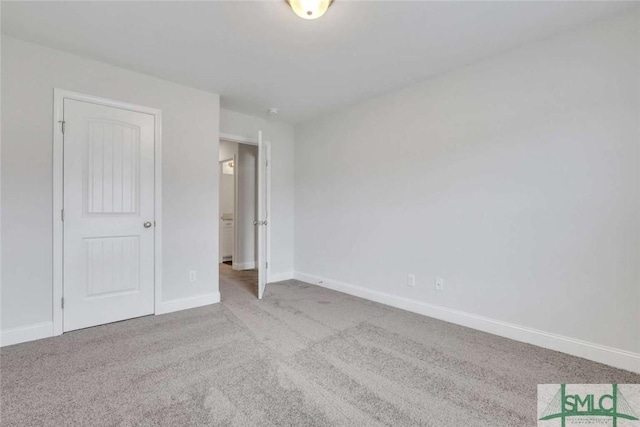 unfurnished room with light colored carpet