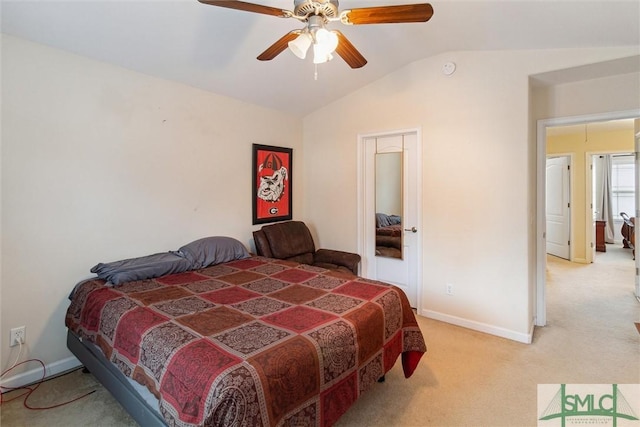 carpeted bedroom featuring lofted ceiling and ceiling fan