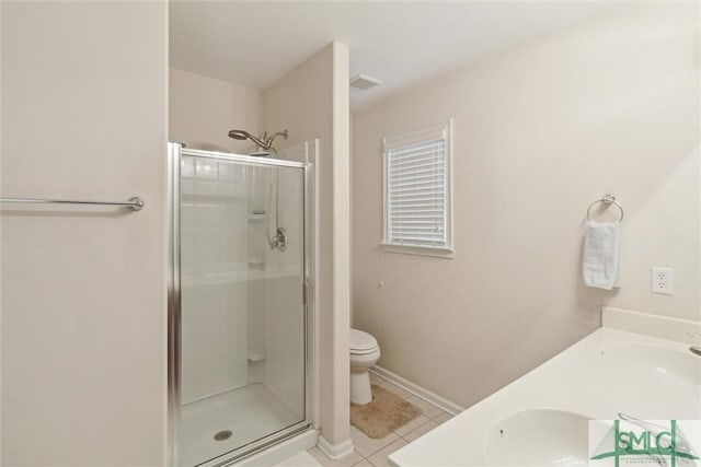 bathroom with tile patterned floors, toilet, a shower with shower door, and vanity