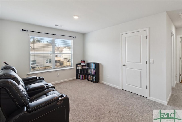 sitting room featuring light carpet