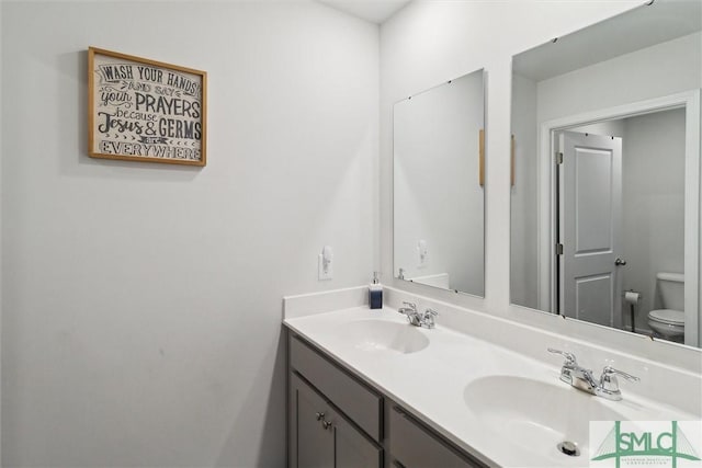 bathroom featuring vanity and toilet