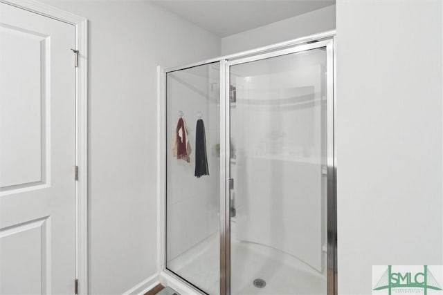 bathroom with a shower with door