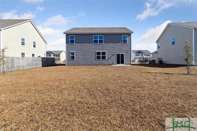 rear view of house with a yard