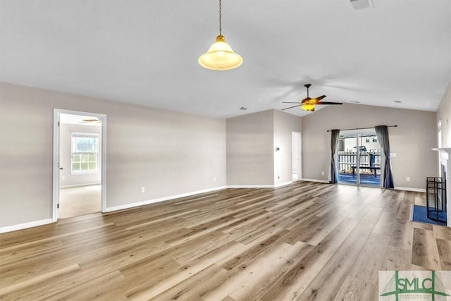 unfurnished living room with baseboards, wood finished floors, lofted ceiling, and ceiling fan