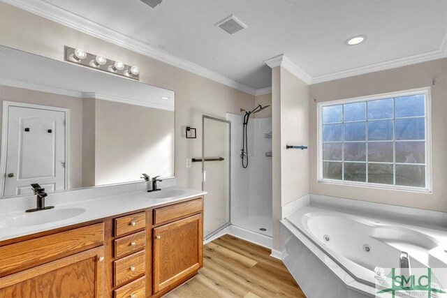 bathroom with crown molding, wood-type flooring, vanity, independent shower and bath, and a wealth of natural light