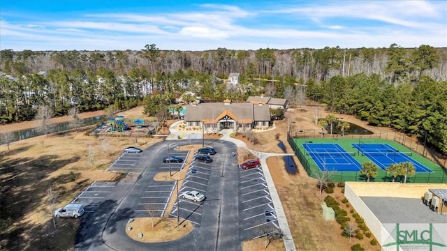 bird's eye view with a wooded view