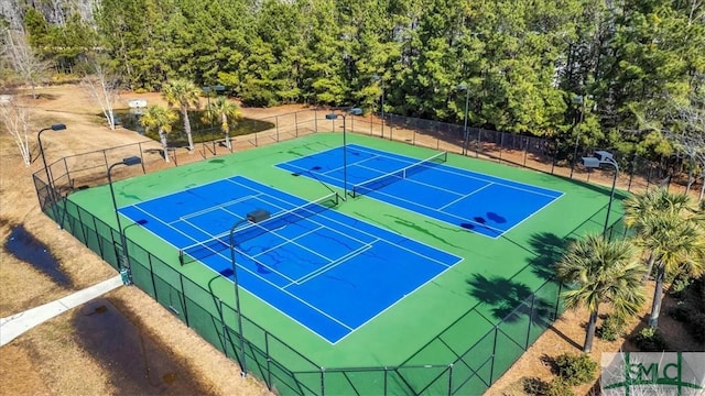 view of sport court featuring fence