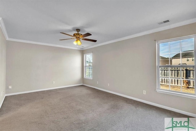 carpeted empty room with visible vents, baseboards, ceiling fan, and ornamental molding